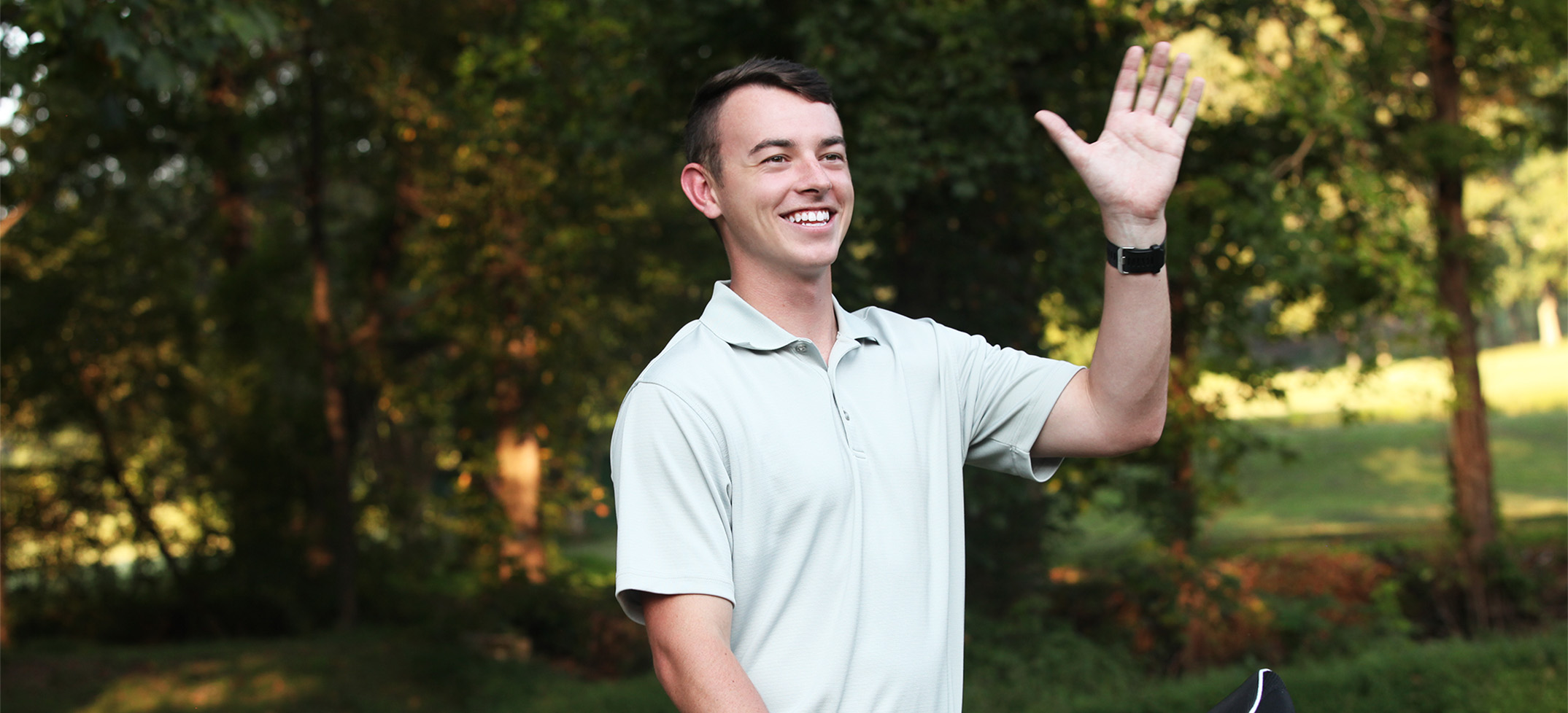 Smiling golfer waving