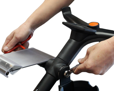 Cup holder nut being tightened into place with scorecard holder on opposite side.